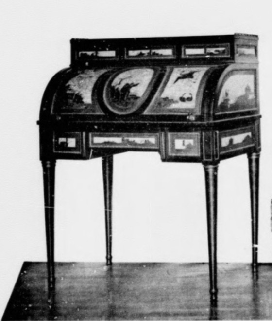Claude-Charles Saunier							<br>							<em>“Small cylinder desk with veneer decoration on the cylinder, the drawers of the belt, the drawers of the upper section, and ends of the lacquer panels with a white background decorated with Chinese characters and in colour. The panels are surrounded with gilded bronze waterleafs. Louis XVI period”</em>